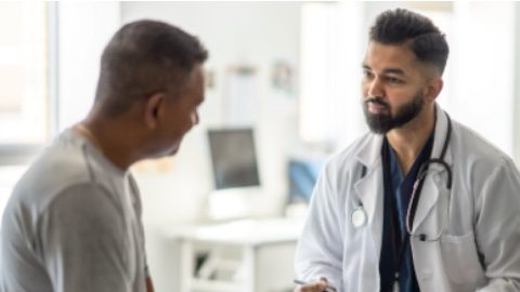 Colorectal surgeon doctor explains colon and other gastrointestinal cancers to a colorectal cancer patient.