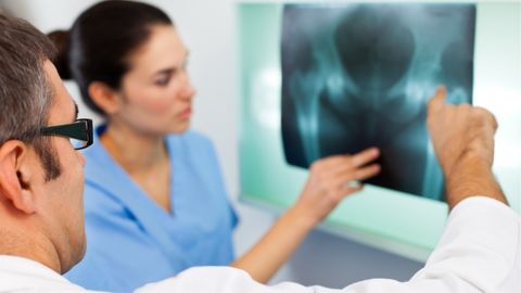 An orthopedic doctor provides hip orthopedic services to a patient.