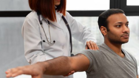 An orthopedic doctor provides shoulder and elbow orthopedic services to a patient.