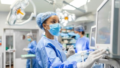 Vascular surgeon performing procedure on patient.