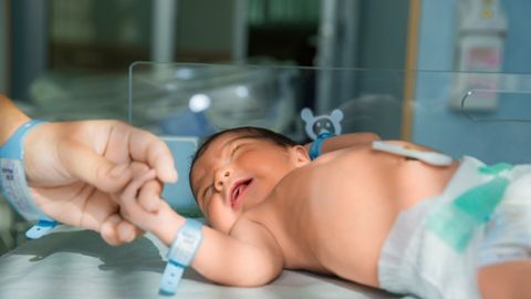 A baby is being cared for in the neonatal intensive care unit (NICU).