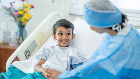 A pediatric surgeon is visiting a pediatric patient post pediatric surgery.